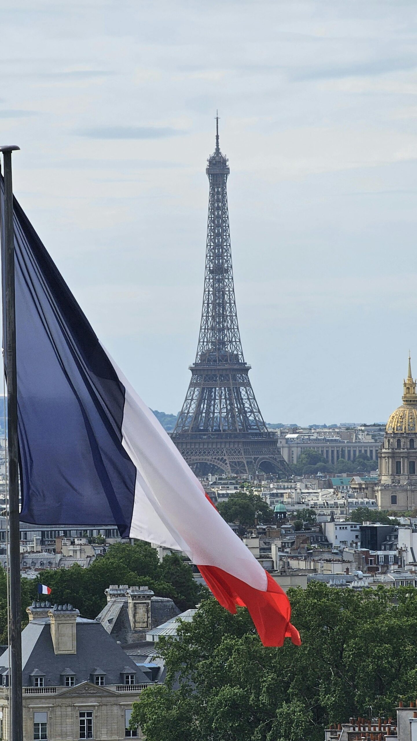 Stunning view of the Eiffel Tower framed by a French flag, capturing the essence of Paris.